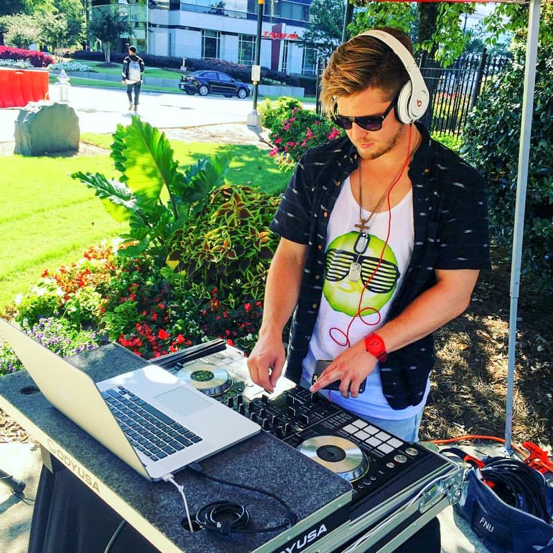 A DJ spinning at an outdoor party.