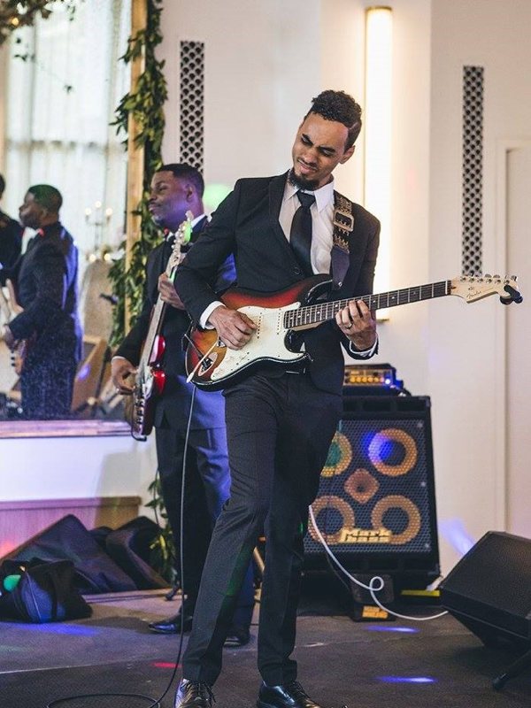 An electric guitarist jamming out at an event.