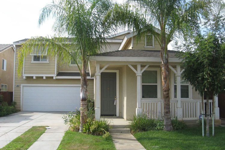 exterior of 3946 Coral Gables; two-story house with front porch and palm trees