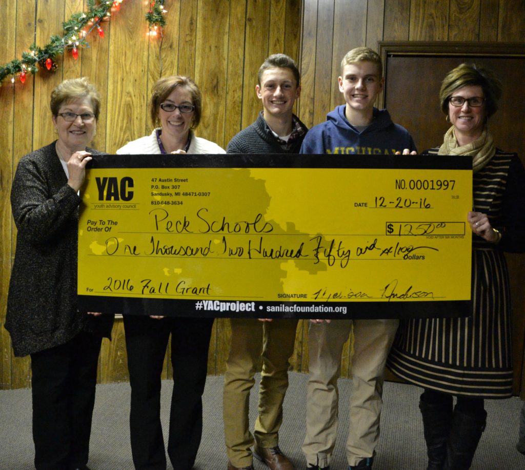 five people holding a large check from YAC 2016 Fall Grant for Peck Schools