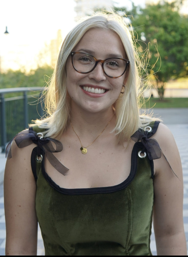 smiling young woman with tortoiseshell colored glasses